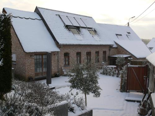 a house with snow on the roof at Casa della Nonna in Zwalm