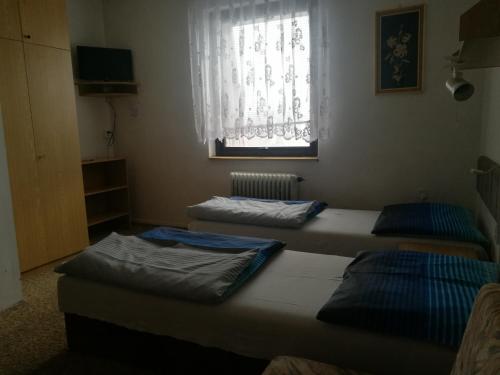 Postel nebo postele na pokoji v ubytování Pension Sport