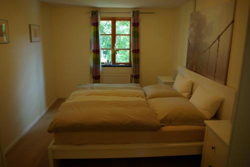 a bed sitting in a room with a window at Sternenhimmel in Bleckede