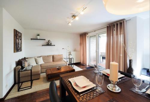 a living room with a couch and a table at Buddha's Place - Hohen-Wieschendorf in Hohen Wieschendorf