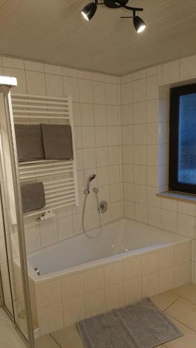 eine Badewanne im Bad mit Fenster in der Unterkunft Ferienwohnung Sandner in Nüdlingen