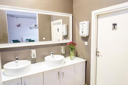a bathroom with two sinks and a mirror at The Corner Inn Hotels By Suit in Eskisehir