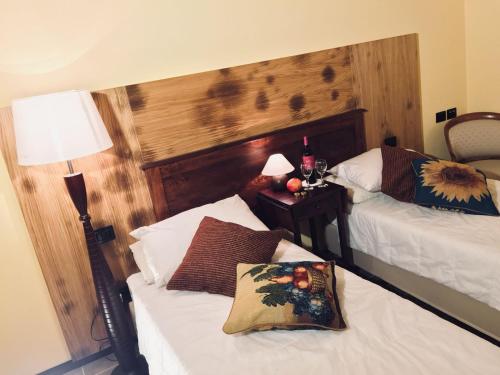 a bedroom with two beds and a table with a lamp at Villa Brettino- Pesaro mare e cultura - intera struttura con piscina in Fano