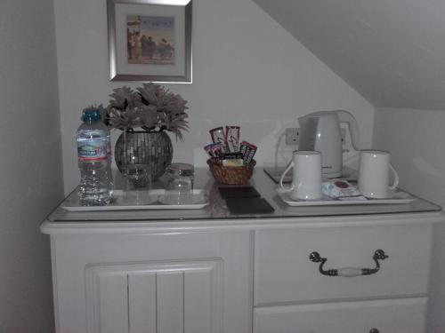 a white cabinet with a counter top with a vase on it at Eastdale Bed and Breakfast in North Ferriby