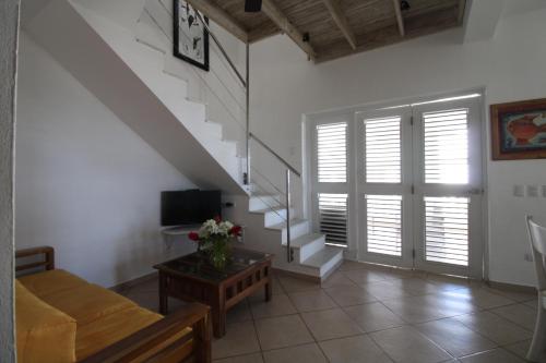 a living room with a staircase and a couch at Albachiara Hotel - Las Terrenas in Las Terrenas