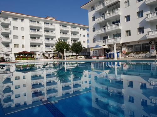 a swimming pool in front of a hotel at Europa Family Apartments in Blanes
