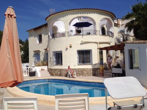 a house with a swimming pool in front of a house at Casa Pauline in Benissa