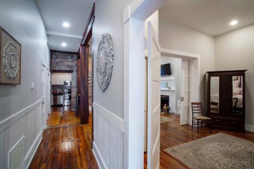 a hallway with white walls and wooden floors at 414 Waldburg A · Newly Renovated Apt with outdoor space! in Savannah