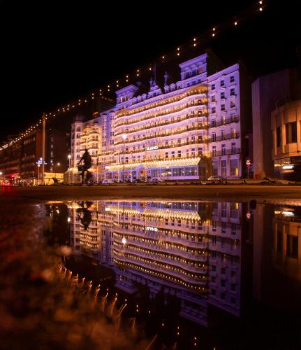 a large building is lit up at night at The Grand Brighton in Brighton & Hove