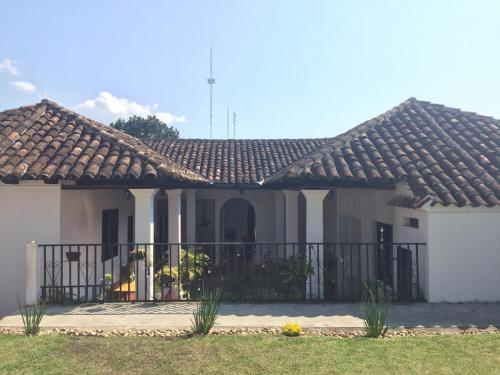 a house with a fence in front of it at Casa LOBE in Ocosingo