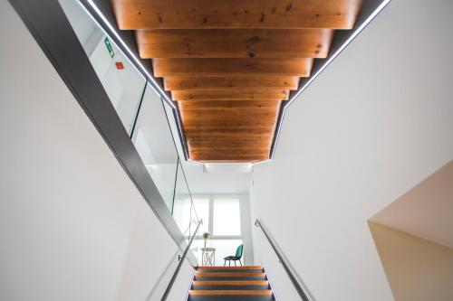 a staircase in a house with a wooden ceiling at DWO Ábaster in Soria