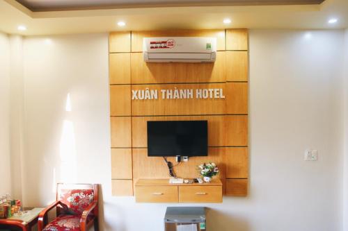 a hotel room with a television and a heater at Xuan Thanh Hotel in Thanh Hóa