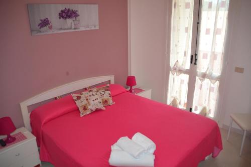 En eller flere senge i et værelse på Apartments Di Salvo
