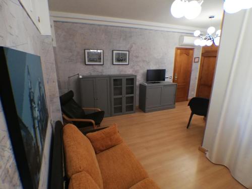 uma sala de estar com um sofá e uma televisão em Hostal Santo Tomé em Toledo