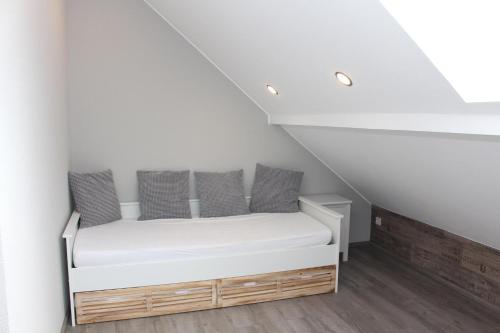 a bedroom with a bed in a attic at Eifel Dream Schneifelhaus in Kobscheid