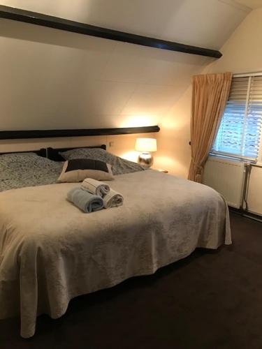 a bedroom with a bed with towels on it at Maison A La Mer in Retranchement