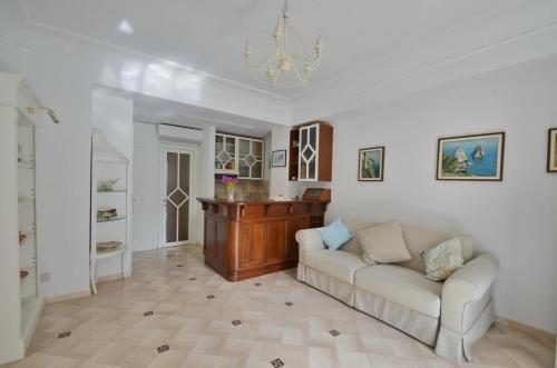 a living room with a couch and a table at CASA GADEAMUS via le botteghe 12 in Capri