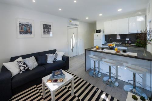 a living room with a couch and a kitchen at I.P.S. Apartment in Dubrovnik
