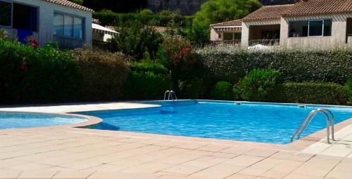 a swimming pool in a yard next to a house at Havre de Paix in Villeneuve-Loubet