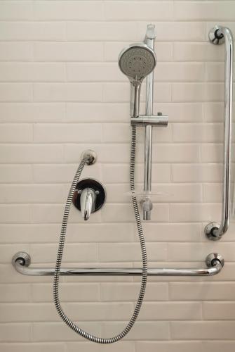 a shower with a shower head in a bathroom at Hotel Luzeiros Fortaleza in Fortaleza