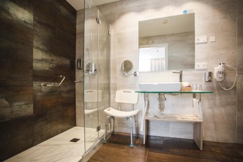 a bathroom with a sink and a glass shower at Hotel Boutique Ábaster in Soria
