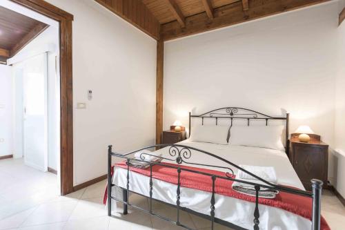 a bedroom with a bed with a metal frame at Eloka in Torre Squillace