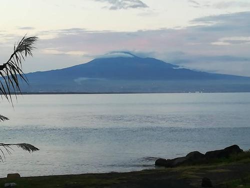 a mountain in the middle of a body of water at Villa Anna in Agnone Bagni
