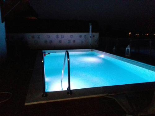 a large swimming pool in a dark room at Villa Anna in Agnone Bagni