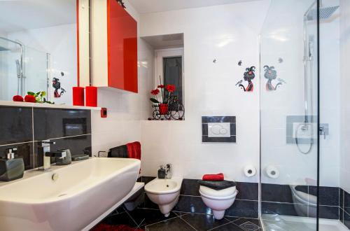 a bathroom with a sink and a toilet and a shower at Carli in Rabac