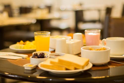 a table topped with plates of food and drinks at Hotel San Pedro Plaza in Cusco