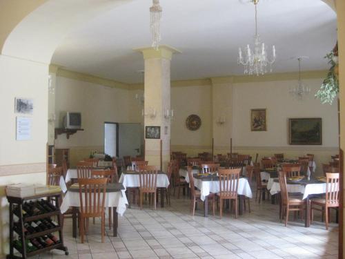 a dining room with tables and chairs and a chandelier at Hotel Gentile in Agerola