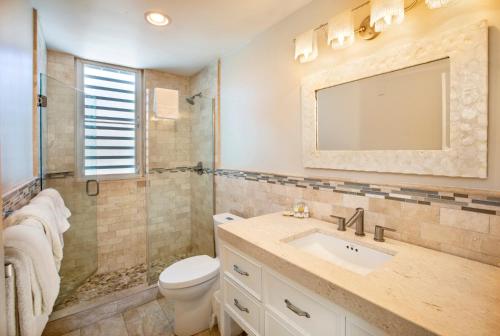a bathroom with a sink and a toilet at Secret Harbour Beach Resort in St Thomas