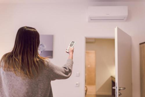 a woman holding a cell phone in front of a mirror at Kings Residence in Prague