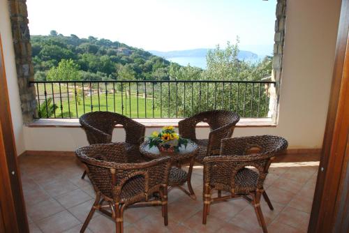 a balcony with a table and chairs and a window at Residence Il Casale in Palinuro