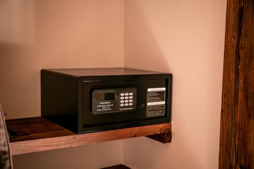 a microwave on a shelf on a wall at Lodge Quelana in San Pedro de Atacama