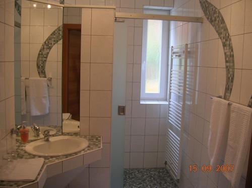 a bathroom with a sink and a mirror at Frühstückspension Krump in Bad Waltersdorf