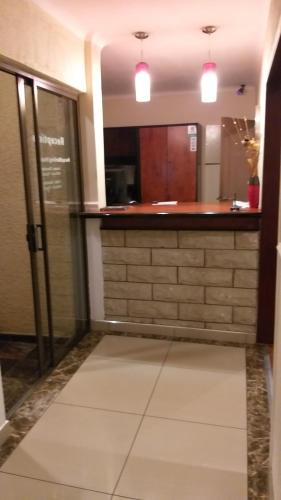 a large room with a kitchen with a counter at Road Stay in Maseru