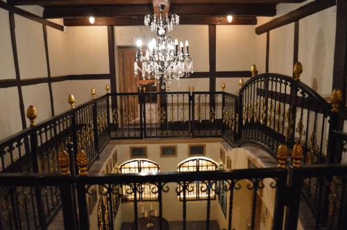 a chandelier hangs from a staircase in a building at Skrøbelev Gods Manor House in Rudkøbing