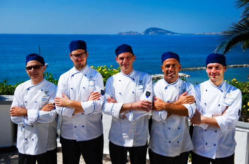 a group of chefs standing in front of the ocean at Grande Albergo Miramare in Formia