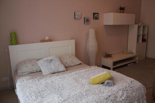 a bedroom with a bed with a white bedspread at KaVi apartments #2 in Plzeň