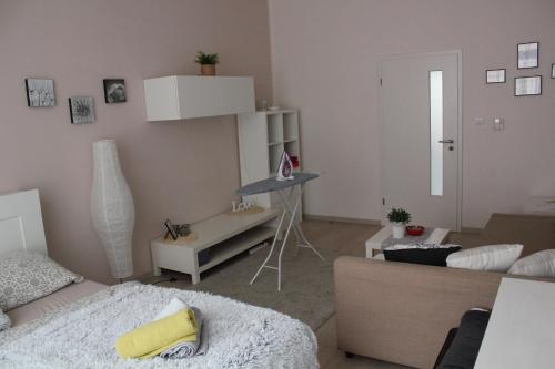 a living room with a bed and a table in it at KaVi apartments #2 in Plzeň
