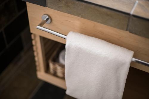 a towel is hanging on the edge of a wooden cabinet at The Juniper Hotel & Bistro in Banff