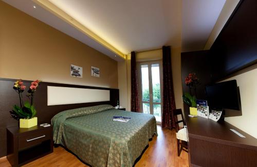 Postel nebo postele na pokoji v ubytování Hotel Verdi