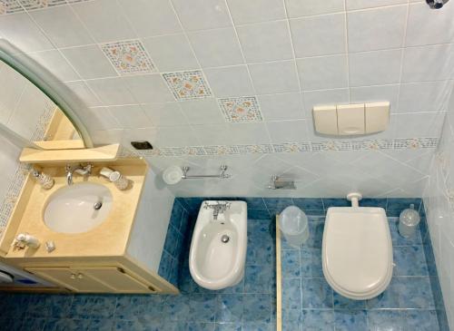 a bathroom with a sink and a toilet and a bidet at Casa Luna in Lipari