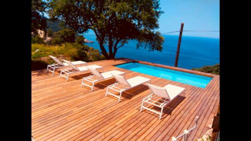 a deck with lounge chairs and a swimming pool at C'an Co Banyalbufar in Banyalbufar