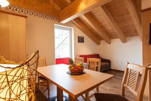 a room with a table with a bowl of fruit on it at ALPENAPART LADIS ehemals Alpenapart Alexander in Ladis