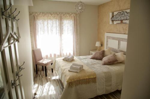 a bedroom with a large bed and a window at Villa Castro in Nuévalos
