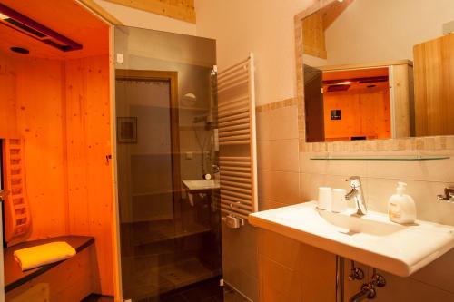 a bathroom with a sink and a shower at ALPENAPART LADIS ehemals Alpenapart Alexander in Ladis