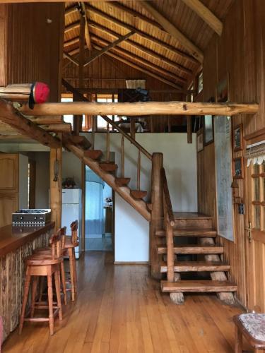 a staircase in a room with wooden walls and wooden floors at Casa Campo Carretera Austral in Puerto Cisnes
