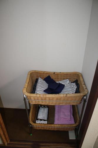 a basket of clothes on a shelf in a room at Hotel Grand Toya in Lake Toya